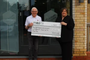 MAD-HR present St Elizabeth’s Hospice with their fundraising towards the Elmer Parade