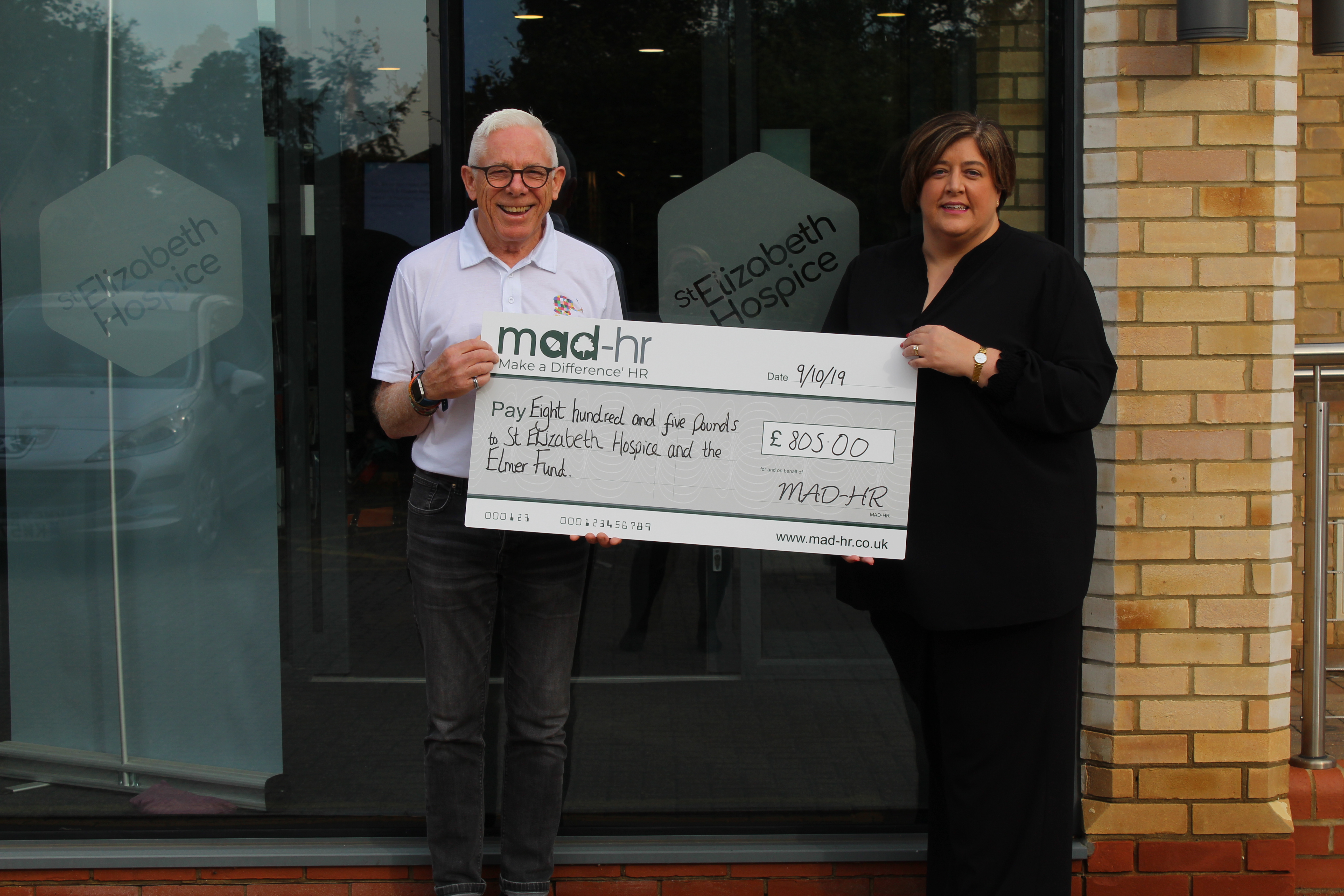 Carole Burman of MAD-HR presents the Elmer Parade fund with their cheque